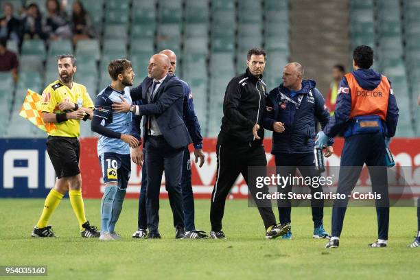 Milos Ninkovic of Sydney is restrained by Melbourne's coach Kevin Muscat when Victory's coaching staff ran on to the field of play after the winning...