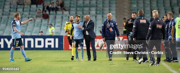 Milos Ninkovic of Sydney is restrained by Melbourne's coach Kevin Muscat when Victory's coaching staff ran on to the field of play after the winning...