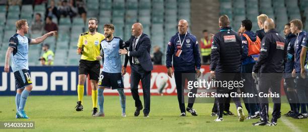 Milos Ninkovic of Sydney is restrained by Melbourne's coach Kevin Muscat when Victory's coaching staff ran on to the field of play after the winning...
