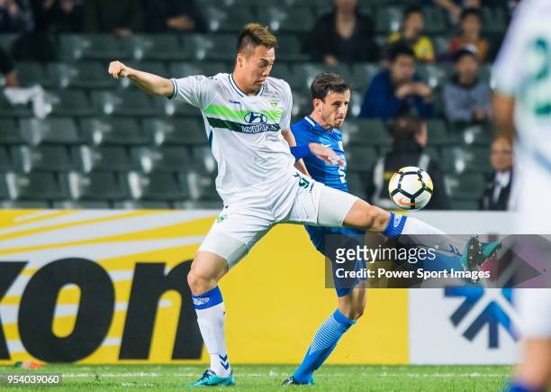 Kim Shinwook of Jeonbuk Hyundai Motors FC competes for the ball with Helio Jose De Souza Goncalves of Kitchee SC during the AFC Champions League...