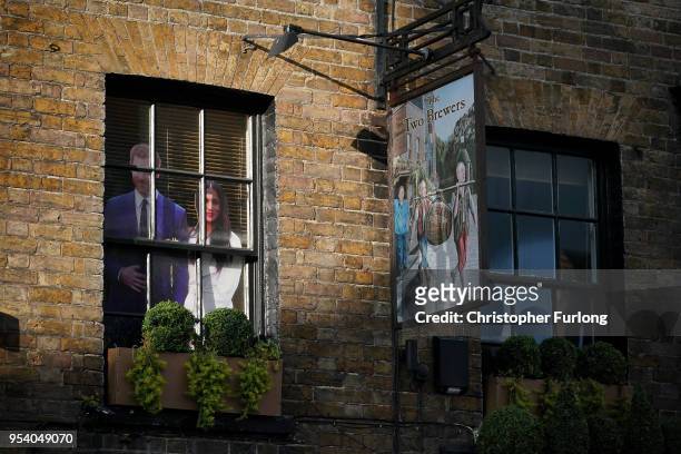 Photograph of Britain's Prince Harry and his fiance, US actress Meghan Markle in the window of the the Two Brewers Pub on May 2, 2018 in Windsor,...