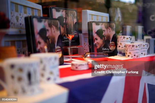 Souvenirs featuring Britain's Prince Harry and his fiance, US actress Meghan Markle are displayed in a gift shop on May 2, 2018 in Windsor, England....