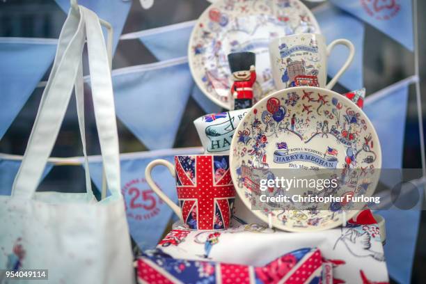 Souvenirs featuring Britain's Prince Harry and his fiance, US actress Meghan Markle are displayed in a gift shop on May 2, 2018 in Windsor, England....