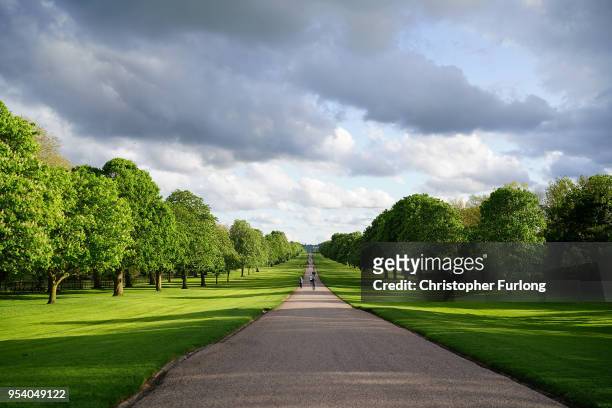 People walk along The Long Walk at Windsor Castle as it prepares for the weddiing of Prince Harry and his fiance, US actress Meghan Markle, May 2,...
