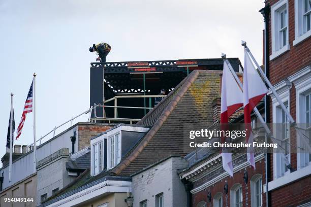 Worker erects amedia stand on a hotel roof as Windsor prepares for the wedding of Prince Harry and his fiance, US actress Meghan Markle, May 2, 2018...