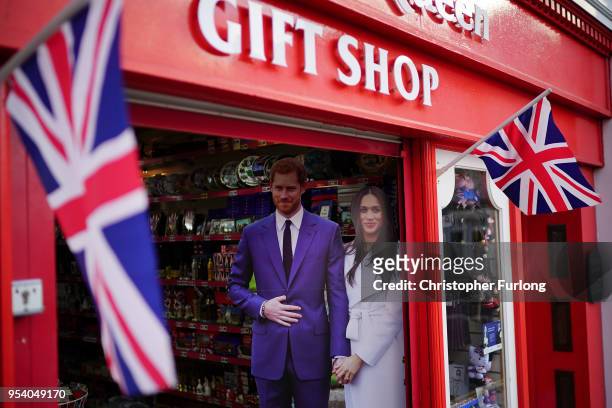 Life size photographs of Britain's Prince Harry and his fiance, US actress Meghan Markle are displayed in a gift shop on May 2, 2018 in Windsor,...