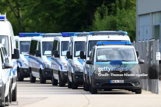 Police vans stand inside at the main refugee center during an intervention there by riot police on May 3, 2018 in Ellwangen, Germany. Police raided...