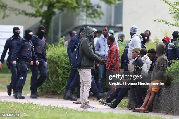 Police an refugees are seen at the main refugee center during an intervention there by riot police on May 3, 2018 in Ellwangen, Germany. Police...