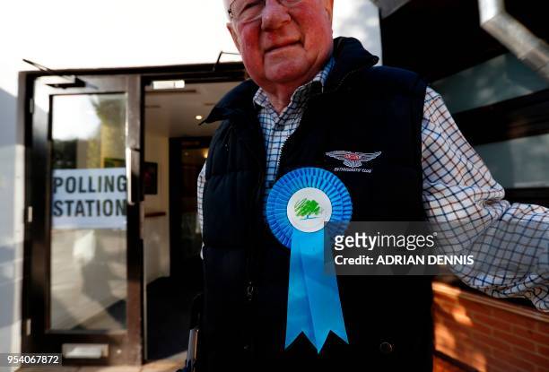Conservative Party teller waits for voters to arrive at a polling station in Hartley Wintney, Hampshire, some 45 miles west of London on May 3, 2018....