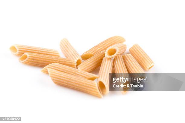 wholemeal pasta penne as close-up shot isolated on white background - vollkorn stock pictures, royalty-free photos & images