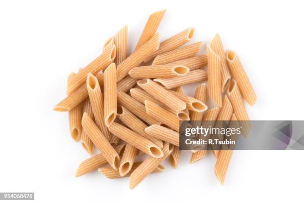 wholemeal pasta penne as close-up shot isolated on white background - vollkorn stock pictures, royalty-free photos & images