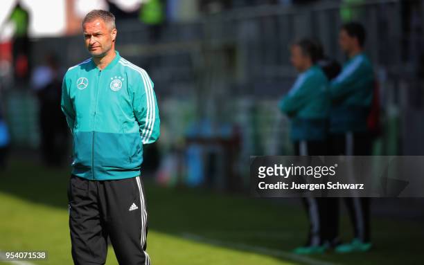 Manager Christian Wueck of Germany watches his team warming up prior to the international friendly match between U15 Germany and U15 Netherlands on...
