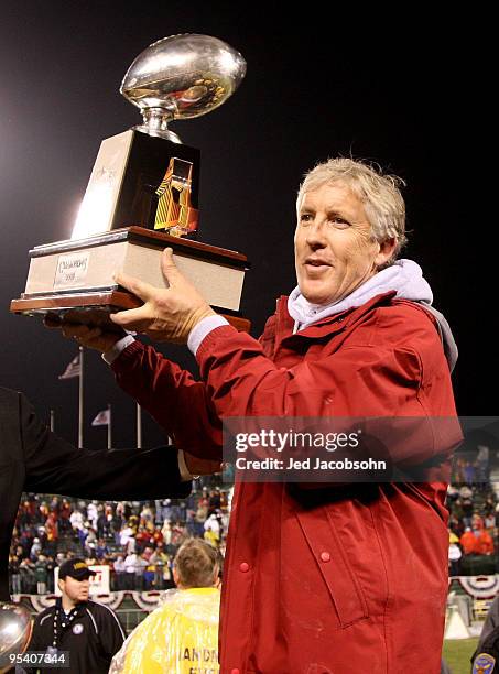 Head coach Pete Carroll of the USC Trojans celebrates after defeating the Boston College Eagles during the 2009 Emerald Bowl at AT&T Park on December...