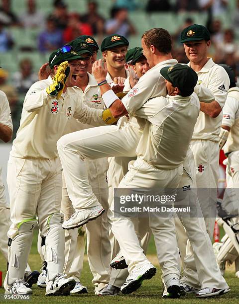 Captain Ricky Ponting of Australia lifts up Peter Siddle as the team celebrates the wicket of Mohammad Yousuf of Pakistan during day two of the First...