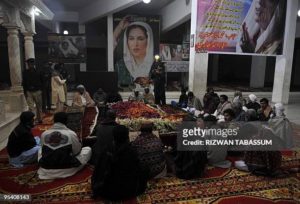 Supporters gather at the grave of slain former Pakistani premier Benazir Bhutto on her second death anniversary in Garhi Khuda Bakhsh late December...