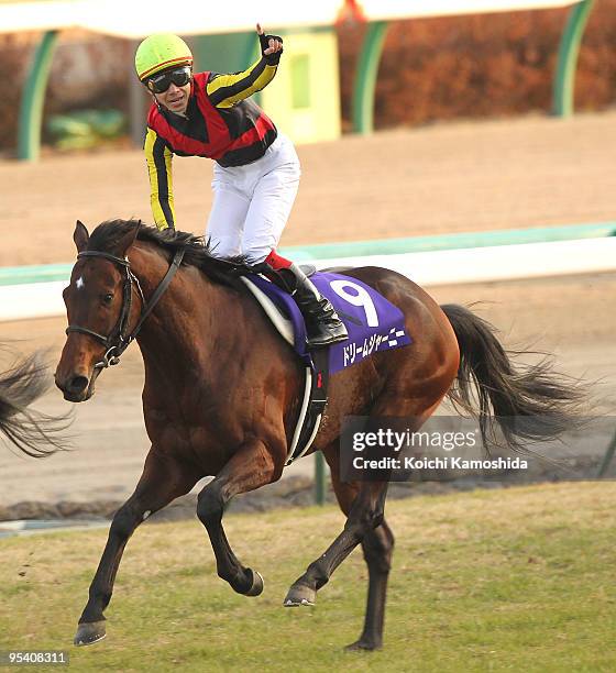 Jockey Kenichi Ikezoe aboard Dream Journey celebrates after winning the 54th Arima Kinen at Nakayama racecourse on December 27, 2009 in Funabashi,...