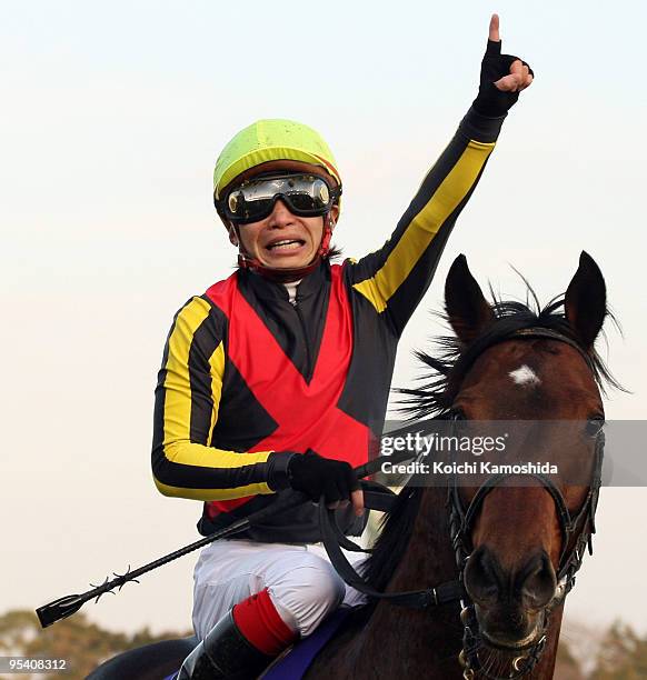 Jockey Kenichi Ikezoe aboard Dream Journey celebrates after winning the 54th Arima Kinen at Nakayama racecourse on December 27, 2009 in Funabashi,...