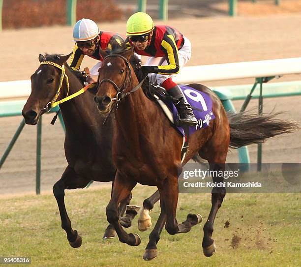 Jockey Kenichi Ikezoe aboard Dream Journey leads jockey Norihiro Yokoyama aboard Buena Vista across the line to win in the 54th Arima Kinen at...