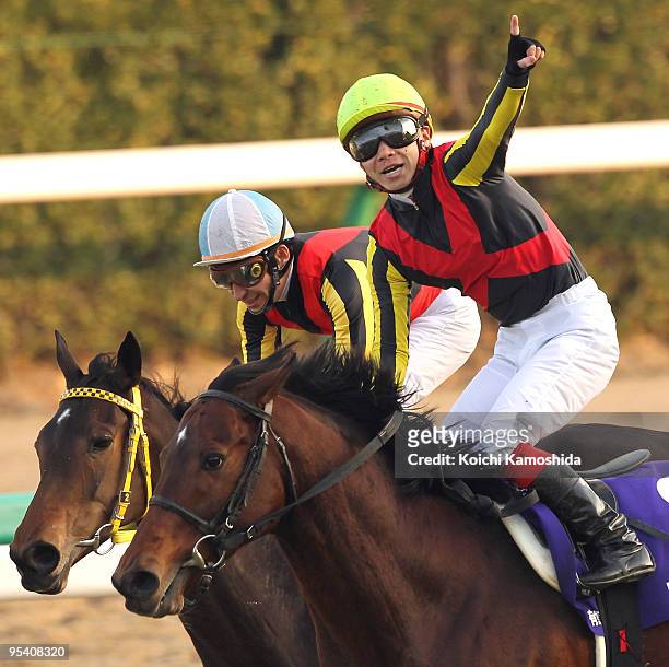 Jockey Kenichi Ikezoe aboard Dream Journey celebrates after winning the 54th Arima Kinen at Nakayama racecourse on December 27, 2009 in Funabashi,...