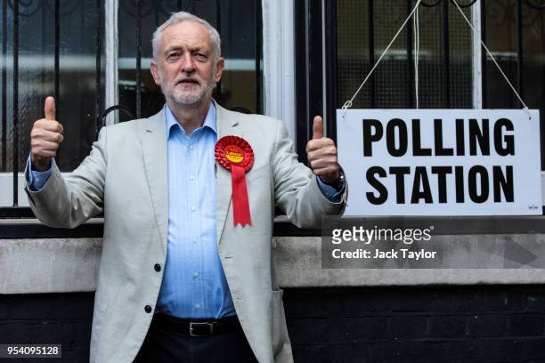 Labour Leader Jeremy Corbyn poses by a sign after voting in local elections at a polling station at Pakeman Primary School on May 3, 2018 in London,...