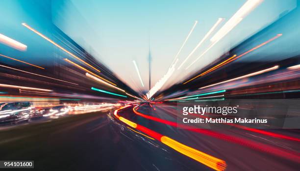 modern creative zoom rush hour night street szene in berlin with traffic lights - street light stock pictures, royalty-free photos & images