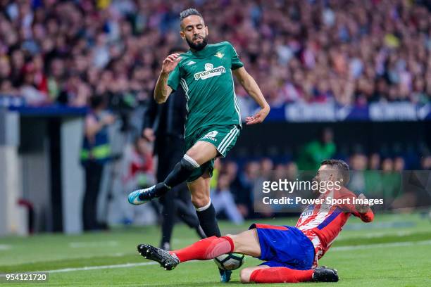 Ryad Boudebouz of Real Betis fights for the ball with Lucas Hernandez of Atletico de Madrid during the La Liga match between Atletico Madrid and Real...