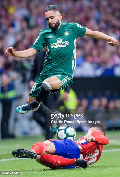 Ryad Boudebouz of Real Betis fights for the ball with Lucas Hernandez of Atletico de Madrid during the La Liga match between Atletico Madrid and Real...