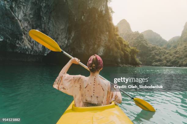 woman kayaking in halong bay - halong bay stock pictures, royalty-free photos & images