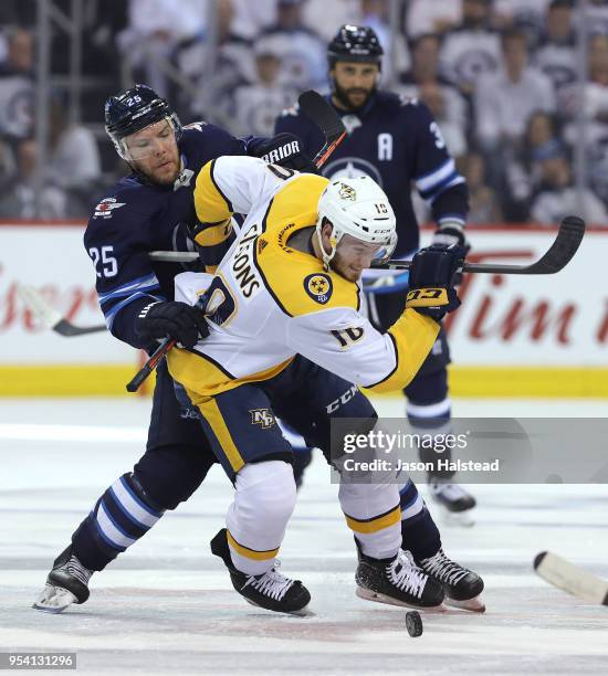 Paul Stastny of the Winnipeg Jets battles Colton Sissons of the Nashville Predators at a face-off in Game Three of the Western Conference Second...