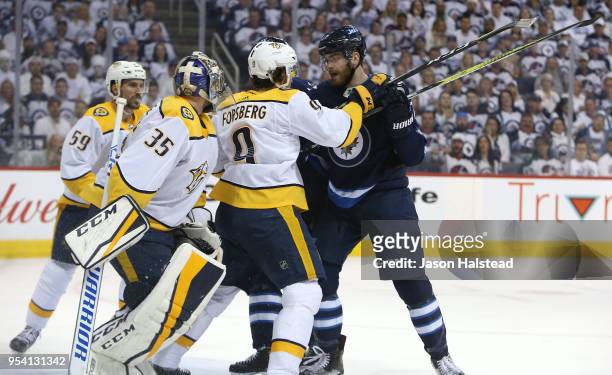 Filip Forsberg of the Nashville Predators fends off Adam Lowry of the Winnipeg Jets in Game Three of the Western Conference Second Round during the...