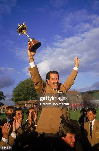 Sam Torrance of the European team celebrates with the trophy after victory over the USA in the Ryder Cup at the Belfry in Sutton Coldfield in...