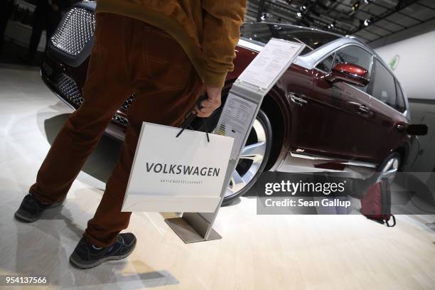 An elderly shareholder of German car manufacturer Volkswagen AG looks at a Bentley Bentayga luxury SUV at Volkswagen's annual general shareholders'...