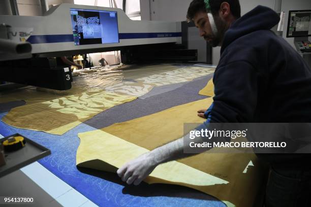 An employee of La Sportiva, brand leader of Climbing shoes, works in La Sportiva Factory in Ziano di Fiemme, Northern Italy, on April 19, 2018.