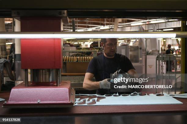 An employee of La Sportiva, brand leader of Climbing shoes, works in La Sportiva Factory in Ziano di Fiemme, Northern Italy, on April 19, 2018.