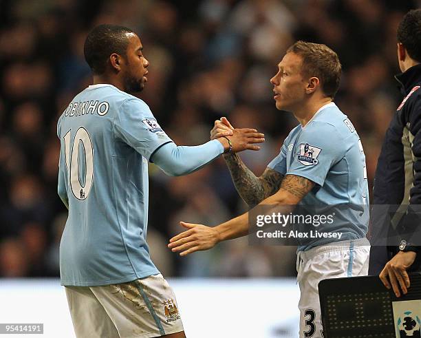 Robinho of Manchester City is substituted for Craig Bellamy during the Barclays Premier League match between Manchester City and Stoke City at City...