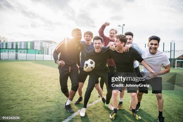 winning football team cheering - soccer ball stock pictures, royalty-free photos & images