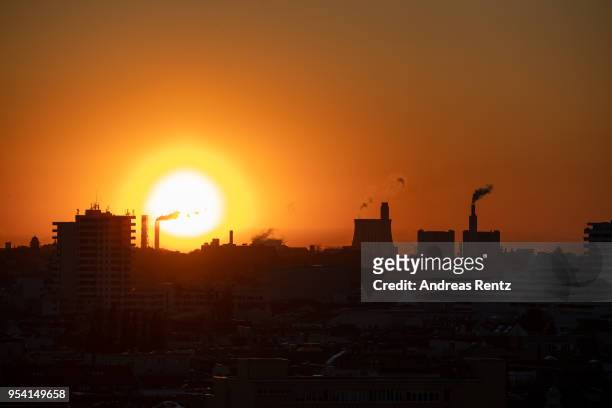 Exhaust rises from the smokestack of a natural gas-burning power and heating plant during sunset on April 30, 2018 in Berlin, Germany.