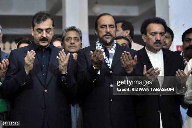 Pakistani Prime Minister Yousuf Raza Gilani , Law Minister Babar Awan and Minister for Interior Rehman Malik pray at the grave of slain former...