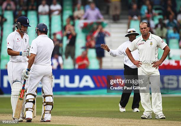 Jacques Kallis of South Africa looks frustrated as Andrew Strauss of England celebrates with Alastair Cook after hitting a boundary for four runs...
