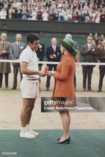 Australian tennis player Ken Rosewall is presented with the runner's up medal by Princess Margaret, Countess of Snowdon after being defeated by John...