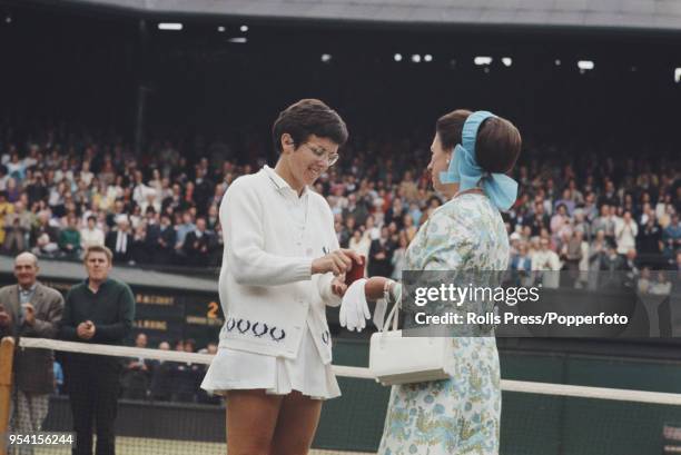 American tennis player Billie Jean King is presented with the runner's up medal by Princess Margaret, Countess of Snowdon after being defeated by...