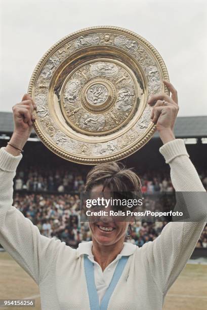 Australian tennis player Margaret Court holds the Venus Rosewater Dish trophy up in the air after defeating Billie Jean King 14-12, 11-9 to win the...