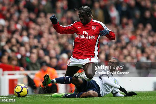 Bacary Sagna of Arsenal is tackled by Ashley Young of Aston Villa during the Barclays Premier League match between Arsenal and Aston Villa at the...