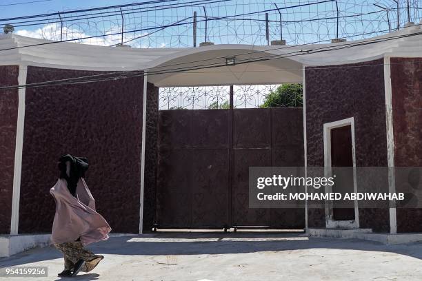 Woman walks in front of the compound of the International Committee of the Red Cross where armed men kidnapped a German nurse on May 3 evening in...