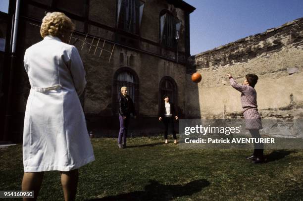 Une surveillante regarde des détenues jouer avec un ballon à la maison d'arrêt en mars 1984 à Riom, France.