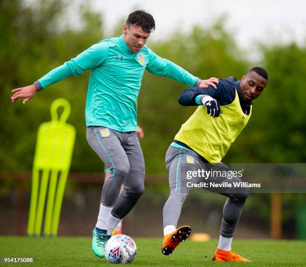 Scott Hogan of Aston Villa in action with team mate Jonathan Kodjia during a training session at the club's training ground at the Recon Training...