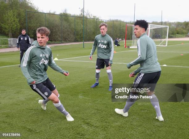 Dion McGhee, Ethan Galbraith and Nishan Burkart of Manchester United U18s in action during an U18s training session at Aon Training Complex on May 2,...