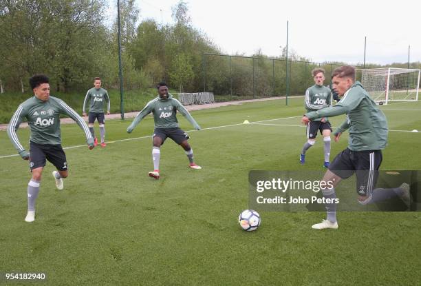 Nishan Burkart, Aliou Traore and Dion McGhee at Aon Training Complex on May 2, 2018 in Manchester, England.