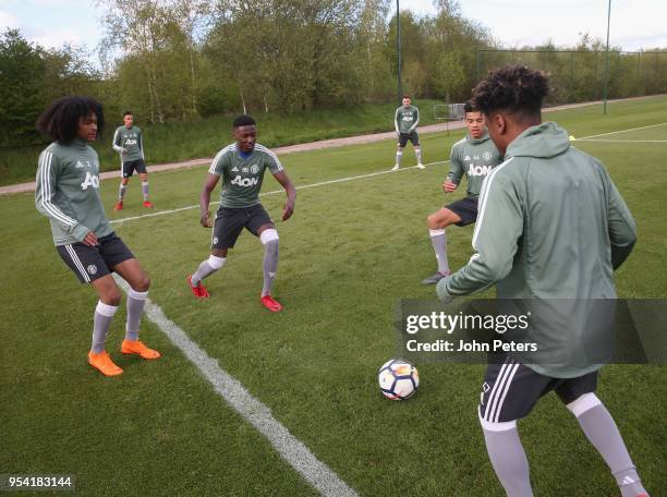 Nishan Burkart, Di'Shon Bernard and Angel Gomes of Manchester United U18s in action during an U18s training session at Aon Training Complex on May 2,...