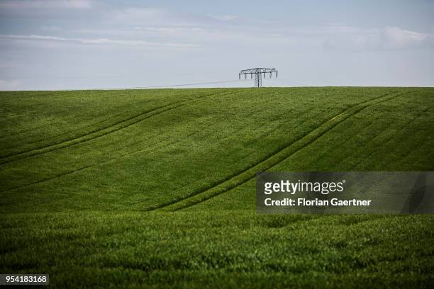 Power pole is located on a green field on April 30, 2018 in Kunnerwitz, Germany.